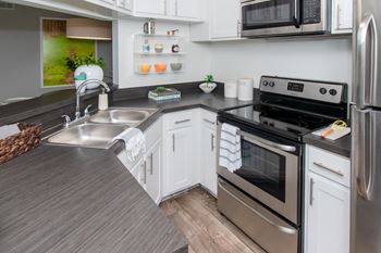 a kitchen with stainless steel appliances and a wooden counter top at Timberwalk at Mandarin, Jacksonville, 32257